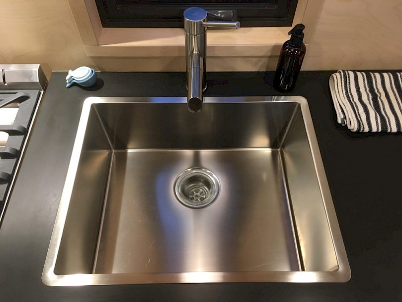 Modern stainless steel kitchen sink in a tiny house