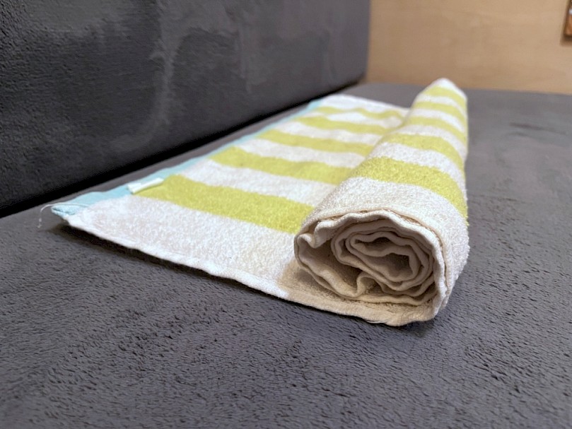 Rolled up beach towel for cervical roll pillow